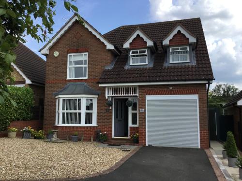 a red brick house with a white garage at The Welcome Home in Sleaford