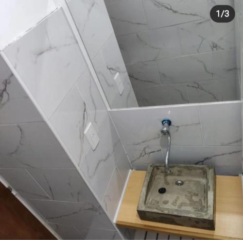 a bathroom with a shower with a sink in it at Hotel Ruta 66 Oficial in Paso de los Libres