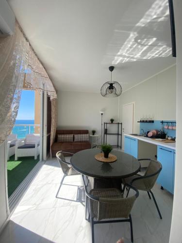 a kitchen and dining room with a table and chairs at Apartment Oskar Beach in Bat Yam