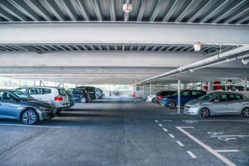 a parking lot filled with lots of parked cars at Holiday Inn - Bordeaux-Merignac by IHG in Mérignac