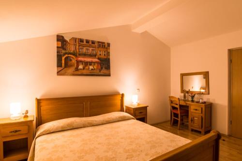 a bedroom with a bed and a desk and a mirror at Villa Calussovo in Ripenda Kras