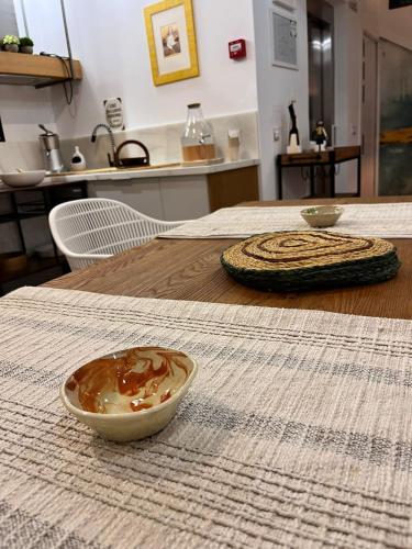 a bowl of food sitting on a wooden table at Hostal Casa de Luna y Sol in Úbeda