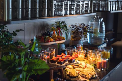 a table with food and jars of fruit and snacks at Quality Hotel Harstad in Harstad