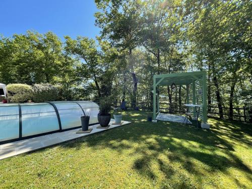 a garden with a gazebo and a fence at Le chalet des Pesettes in Thorens-Glières