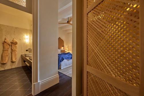 a bathroom with a door leading to a bedroom at Puro Grand Hotel in Palma de Mallorca