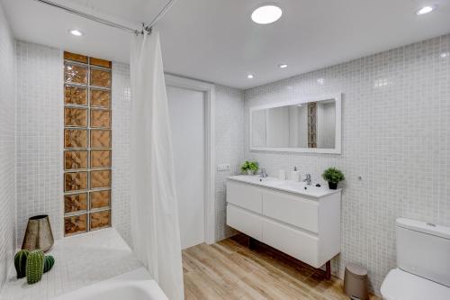 ein weißes Bad mit einem Waschbecken und einem WC in der Unterkunft Precioso Apto Caleta Interian Beach By Paramount Holidays in Caleta de Interián