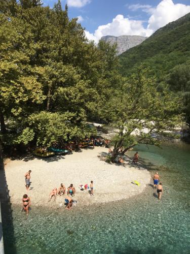 a group of people on a beach in the water at KATIKIA ZAGORI in Vitsa