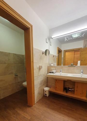 a bathroom with a sink and a mirror at Hotel Klockerhof in Lermoos