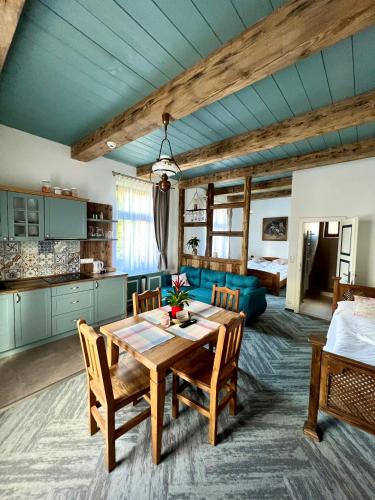 a living room with a table and a blue couch at Vila Liberta in Poprad