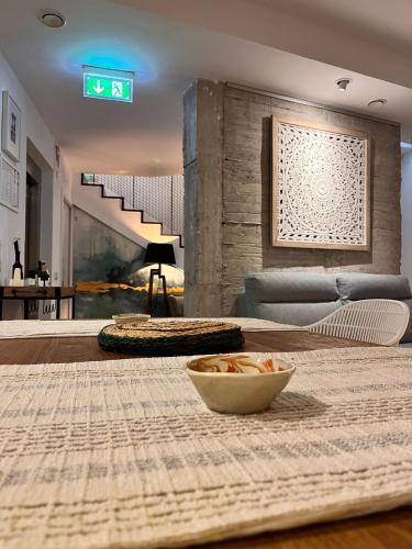 a living room with a table with a bowl on it at Hostal Casa de Luna y Sol in Úbeda