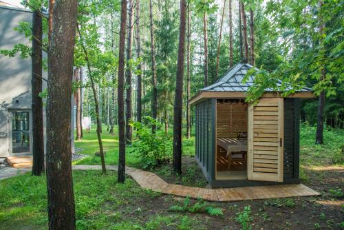 a wooden cabin in the woods with a table in it at SPA VILNIUS Anykščiai in Anykščiai