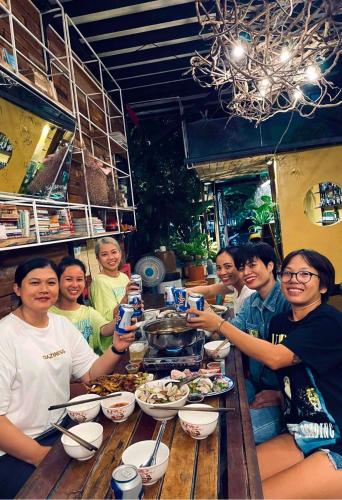 a group of people sitting around a table eating food at Uyen's House in Con Dao