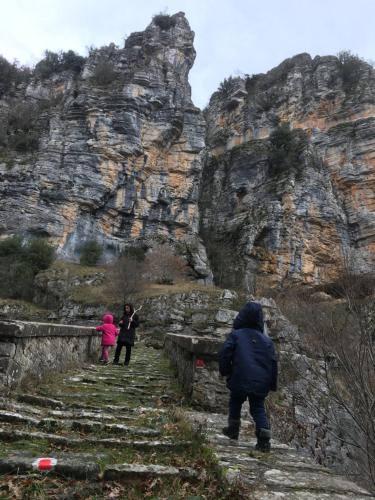 a group of people walking up a stone mountain at KATIKIA ZAGORI in Vitsa