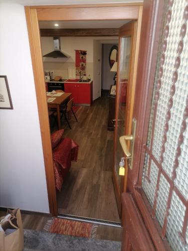 a hallway with a door to a kitchen and a dining room at Bella Vigezzo in Craveggia