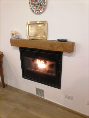 a fireplace in a wall with a mirror on it at Bella Vigezzo in Craveggia