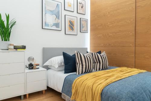 a bedroom with a bed and a white dresser at The Works - Central Manchester Apartment - 2 Parking Spaces in Manchester