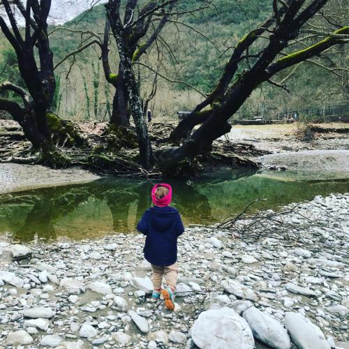 a person standing on the rocks near a river at KATIKIA ZAGORI in Vitsa