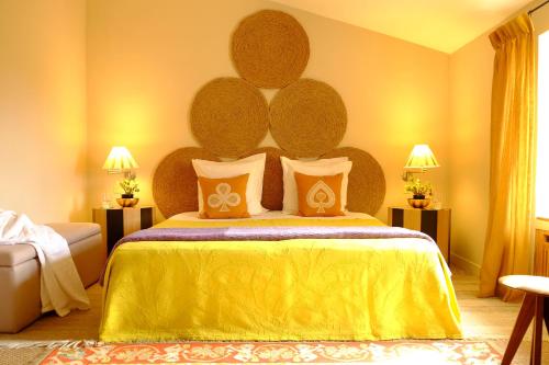 a bedroom with a large bed with a yellow bedspread at Le Pavillon de Galon in Cucuron