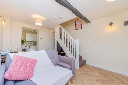 a living room with a couch and a staircase at Coton Hill Shrewsbury Cottage in Shrewsbury