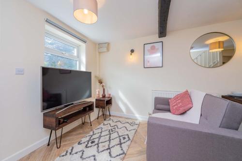 a living room with a large flat screen tv at Coton Hill Shrewsbury Cottage in Shrewsbury