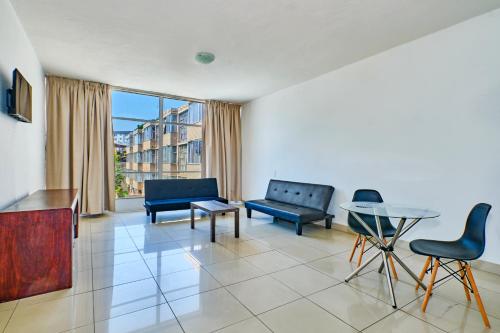a living room with blue furniture and a table at Inn & Out Sandton Park in Johannesburg