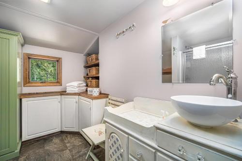 a bathroom with a sink and a mirror at Shady Pines in Thompsonville