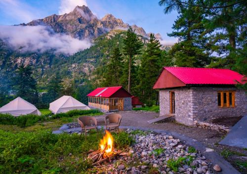 a group of tents with a campfire and a mountain at SAILYA CAMPING AND TREKKING in Saturang