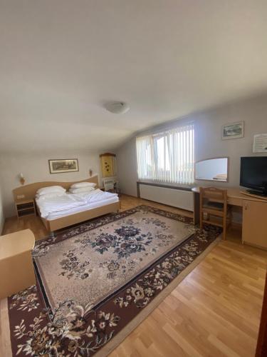 a living room with two beds and a rug at Family Hotel Zdravets in Sofia
