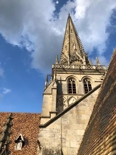 a church steeple on top of a building at LE CHAPITRE - Agréable maison de ville in Autun