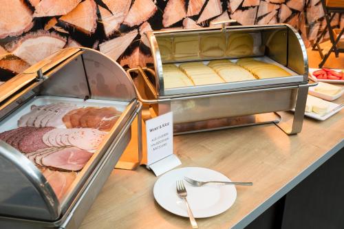 a table with a plate of food on top of it at Hotel Neumaier in Xanten