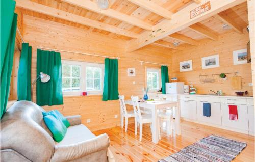 a living room with a table and a kitchen at Beautiful Home In Ustka With Kitchen in Ustka