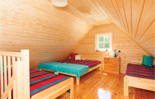 ウストカにあるBeautiful Home In Ustka With Kitchenの木造キャビン内のベッド2台が備わる部屋