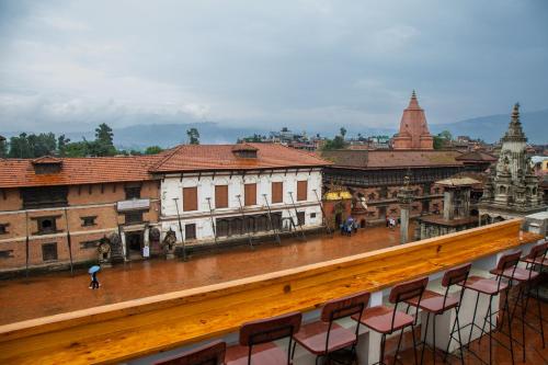 a view of a city from a balcony with chairs at Hotel Traditional in Bhaktapur