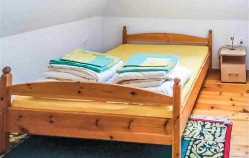 a wooden bunk bed with towels on top of it at Three-Bedroom Holiday Home In Szteklin in Szteklin