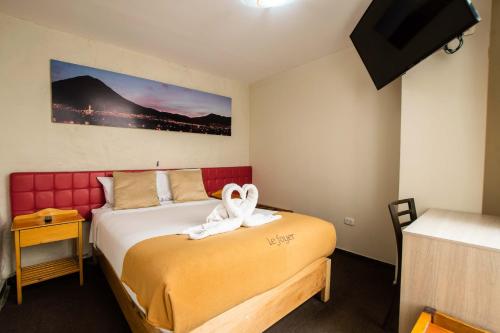 a bedroom with a bed with a towel on it at Le Foyer Arequipa in Arequipa