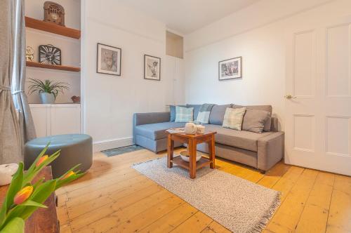 a living room with a couch and a table at Chestnut House Exeter in Exeter