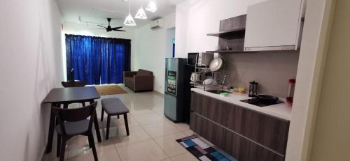 a kitchen with a counter and a table and chairs at New Modern Condo with Pool at Bangi in Kampong Tangkas