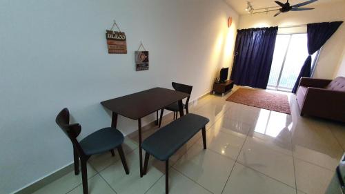 a living room with a table and chairs and a couch at New Modern Condo with Pool at Bangi in Kampong Tangkas