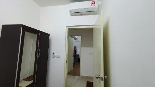 a bathroom with a mirror and a door to a hallway at New Modern Condo with Pool at Bangi in Kampong Tangkas