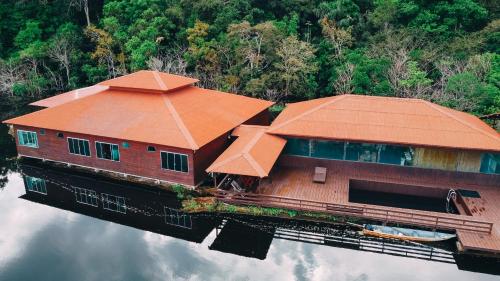 an image of a house on the water at Amazon Arowana Lodge in Careiro