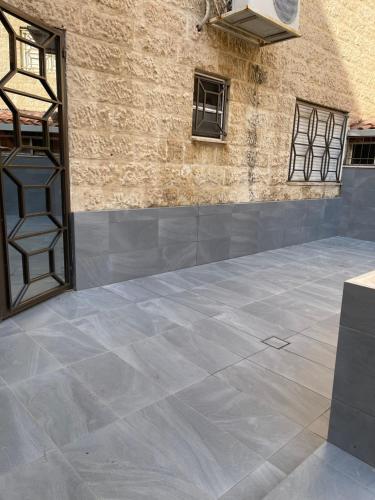a tile floor in a room with a wall at A Luxury 2 Bedroom With a perfect location in Sweifiyeh in Amman