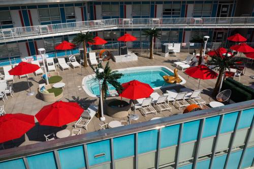a swimming pool with red umbrellas on a cruise ship at Unscripted Durham, Part of JDV by Hyatt in Durham