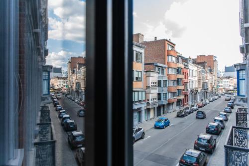 a view from a window of a city street with cars at Appartement Guillemins Station Terrace in Liège