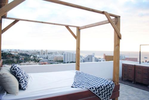 a bed on a balcony with a view of the city at Villa Casa Blanca in Adeje