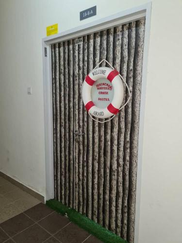 a door to a room with a life preserver at Sekinchan PaddyCruise Homestay Wifi in Sekincan