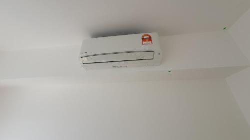 a close up of a white printer on a wall at New Modern Condo with Pool at Bangi in Kampong Tangkas