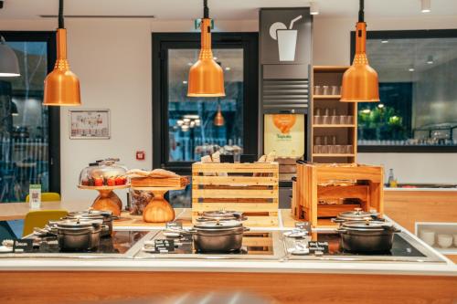 a kitchen with pots and pans on a counter at Holiday Inn - Bordeaux-Merignac by IHG in Mérignac