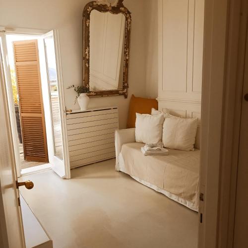 a bedroom with a bed and a mirror on the wall at Casa Palmira in La Spezia