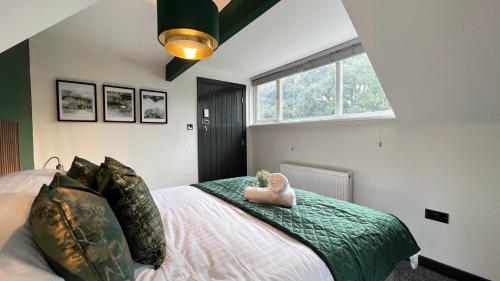 a bedroom with a bed with a stuffed animal on it at Park View in Headingley