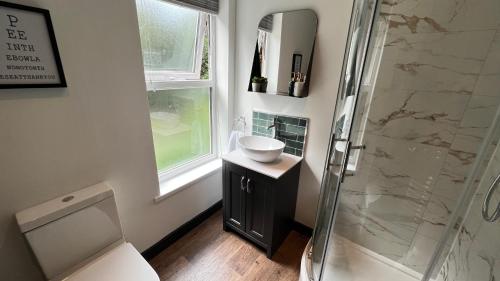 a bathroom with a shower and a sink and a toilet at Park View in Headingley